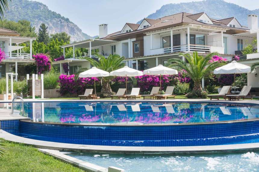 Prestigious Fethiye Seafront Apartment For Sale - Main view of apartment and communal pool