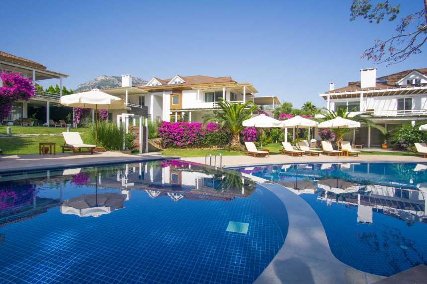 Prestigious Fethiye Seafront Apartment For Sale - View across the pools to apartment building