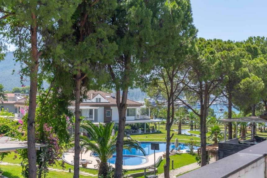 A Seafront Duplex Apartment For Sale in Fethiye - Main view of the pretty apartment block and gardens