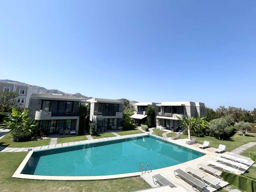 An Immaculate Terrace Apartment For Sale In Bodrum - A large communal pool and pretty shared gardens