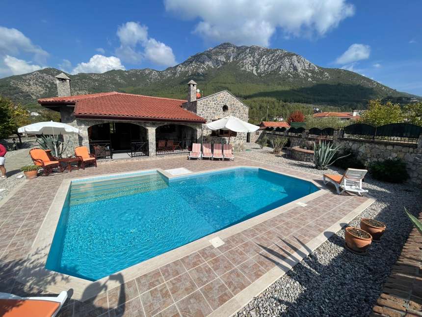 Ready-To-Move Uzumlu Stone Bungalow For Sale - Main view of the bungalow and beautiful surroundings